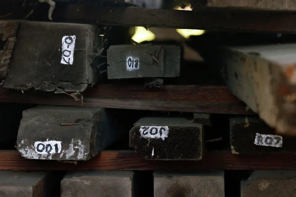 Timber catalogued by a historical archeologist is stacked at the Carrillo Adobe site.
