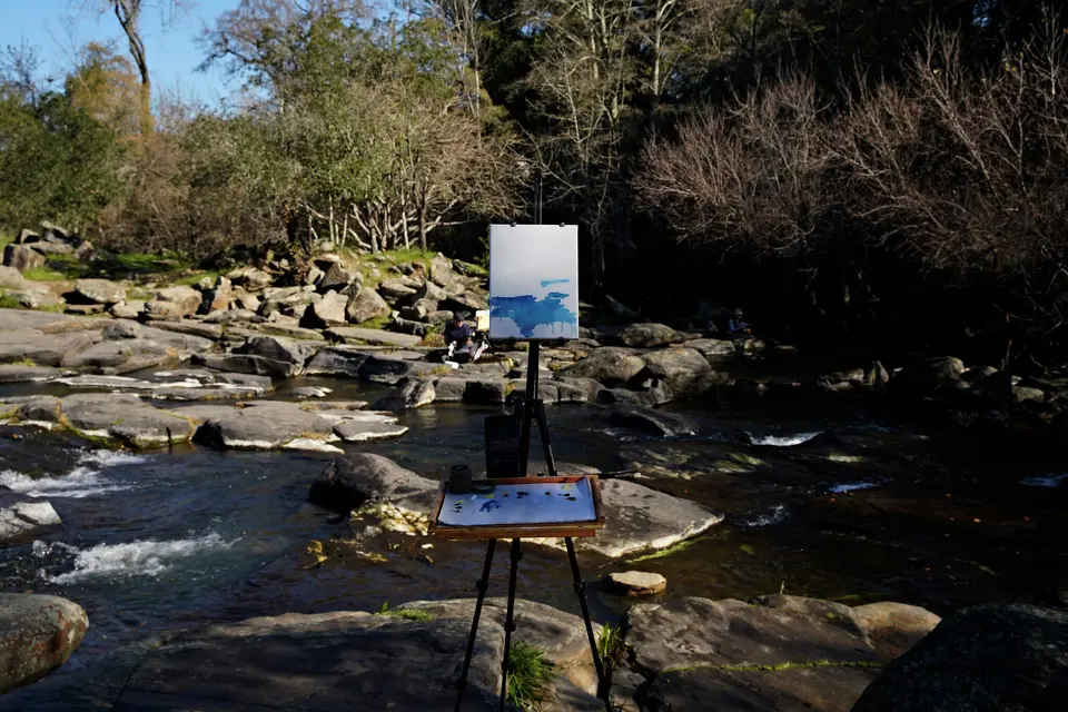 An easel from a painting group is set along Santa Rosa Creek. According to legend, the creek, near Carrillo Adobe, was the site of a baptism that gave the city its name.