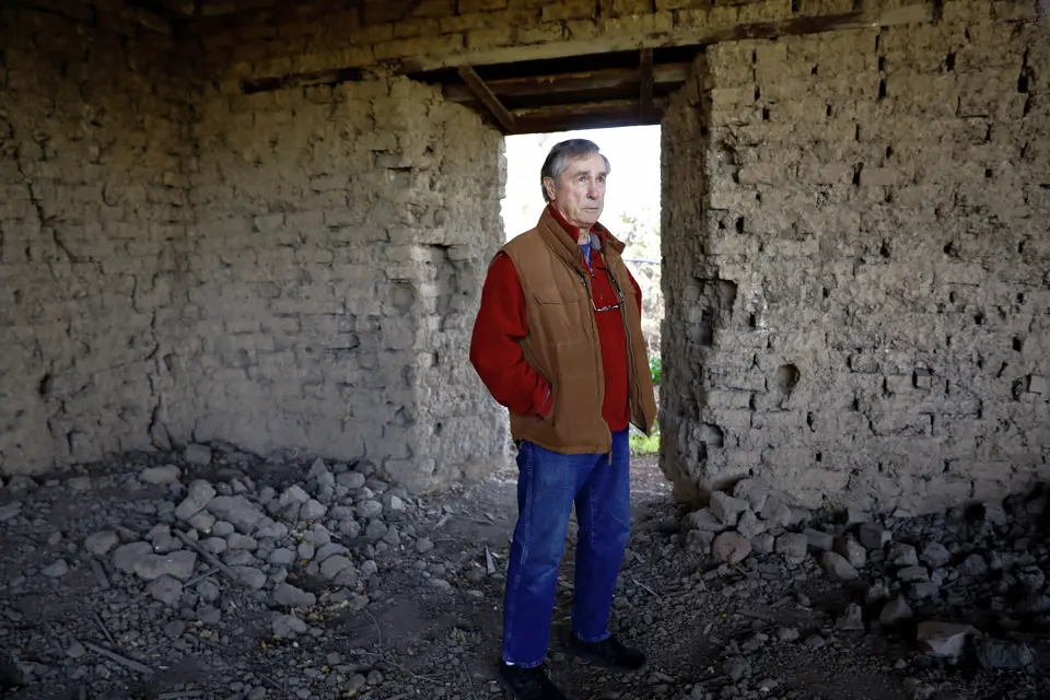 Larry Carrillo standing in Adobe ruins