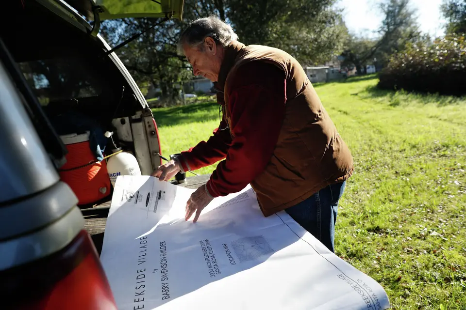 Larry Carrillo looking over development plans